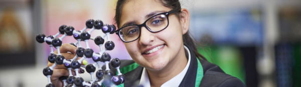 Student with an atoms model in a science lesson